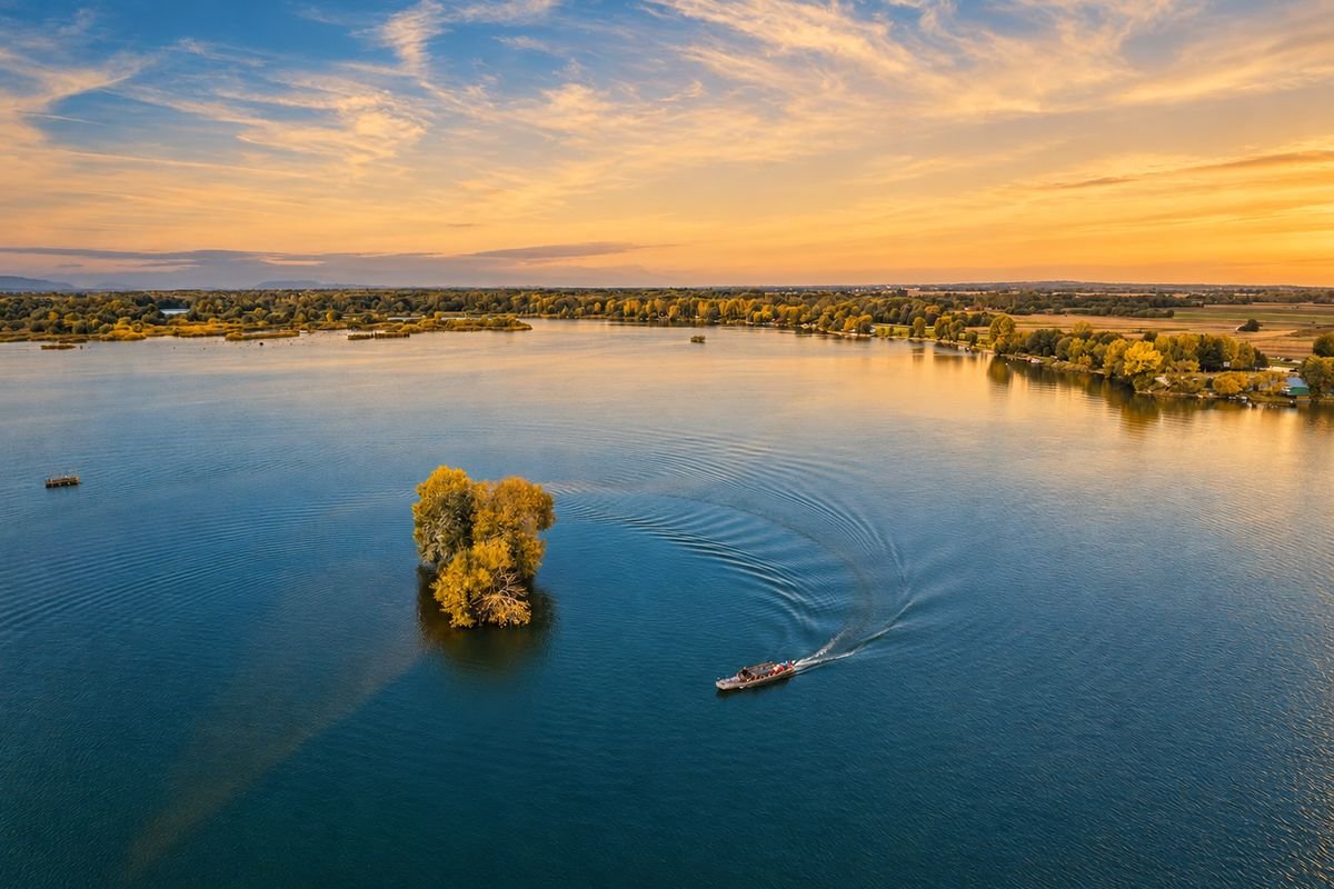 Open water and a boat at the end of the day